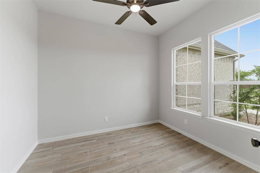 9007 County Road 623, Blue Ridge, TX 75424 Unfurnished room with light wood-style floors and ceiling fan