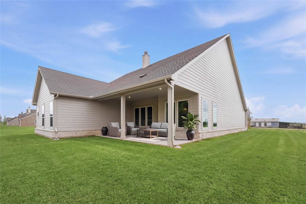 9007 County Road 623, Blue Ridge, TX 75424 Expansive backyard with a covered patio, featuring a gabled roofline and siding exterior