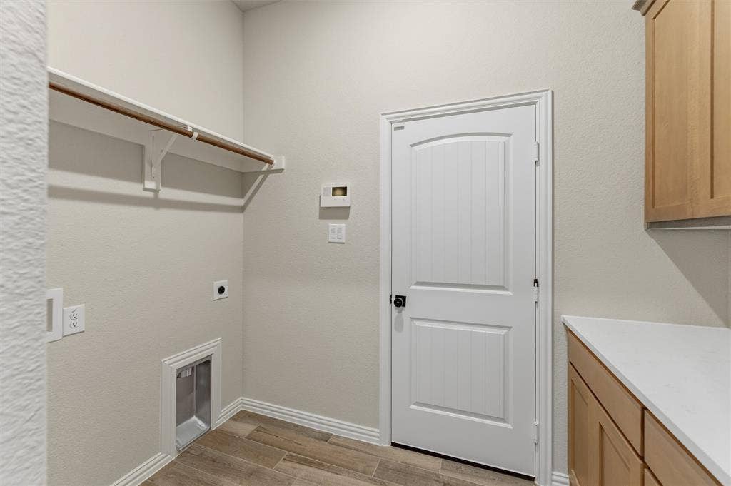 9007 County Road 623, Blue Ridge, TX 75424 Laundry room featuring light wood-style flooring and hookup for an electric dryer