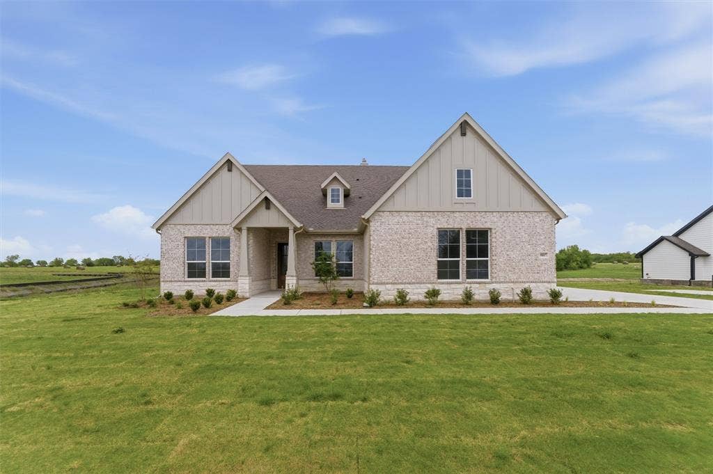 9007 County Road 623, Blue Ridge, TX 75424 View of front of house featuring board and batten siding, brick siding, and a front lawn