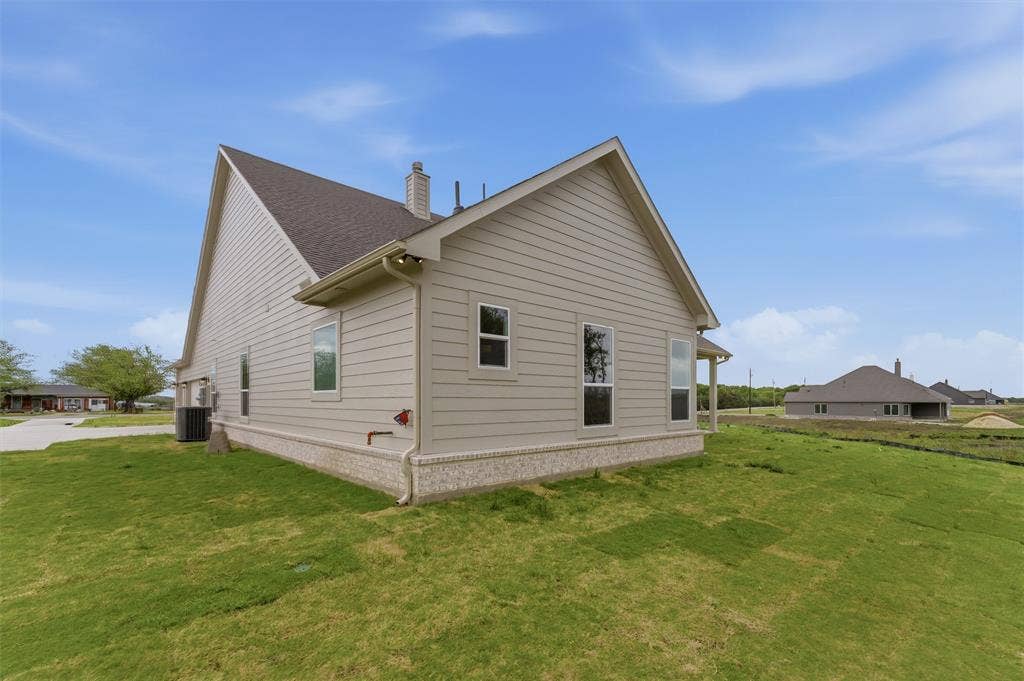 9007 County Road 623, Blue Ridge, TX 75424 View of side of home featuring a lawn and a chimney