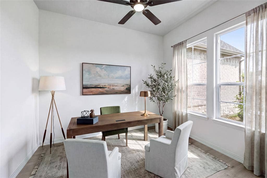 9007 County Road 623, Blue Ridge, TX 75424 Hardwood-style flooring, white walls, two large windows, and a ceiling fan with integrated lighting