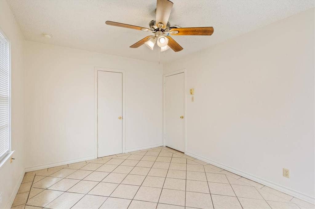 2424 S 26th Street, Waco, TX 76706 Unfurnished room with a ceiling fan and light tile patterned flooring