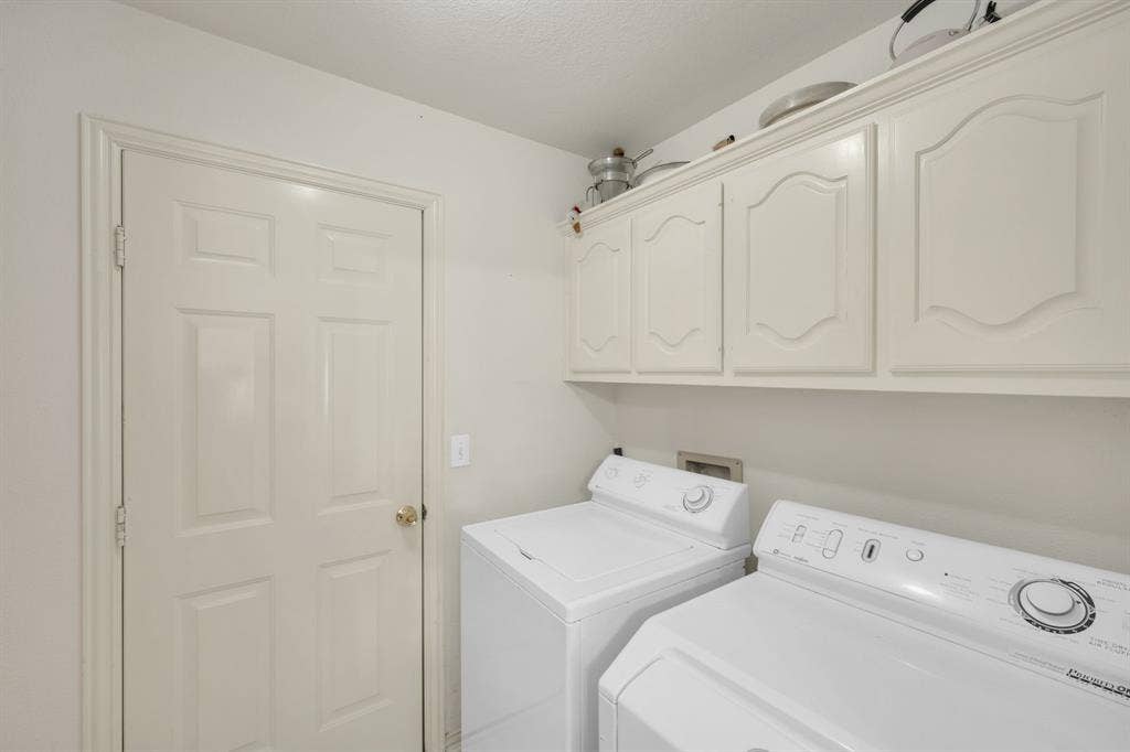 Laundry room with cabinet space and independent washer and dryer