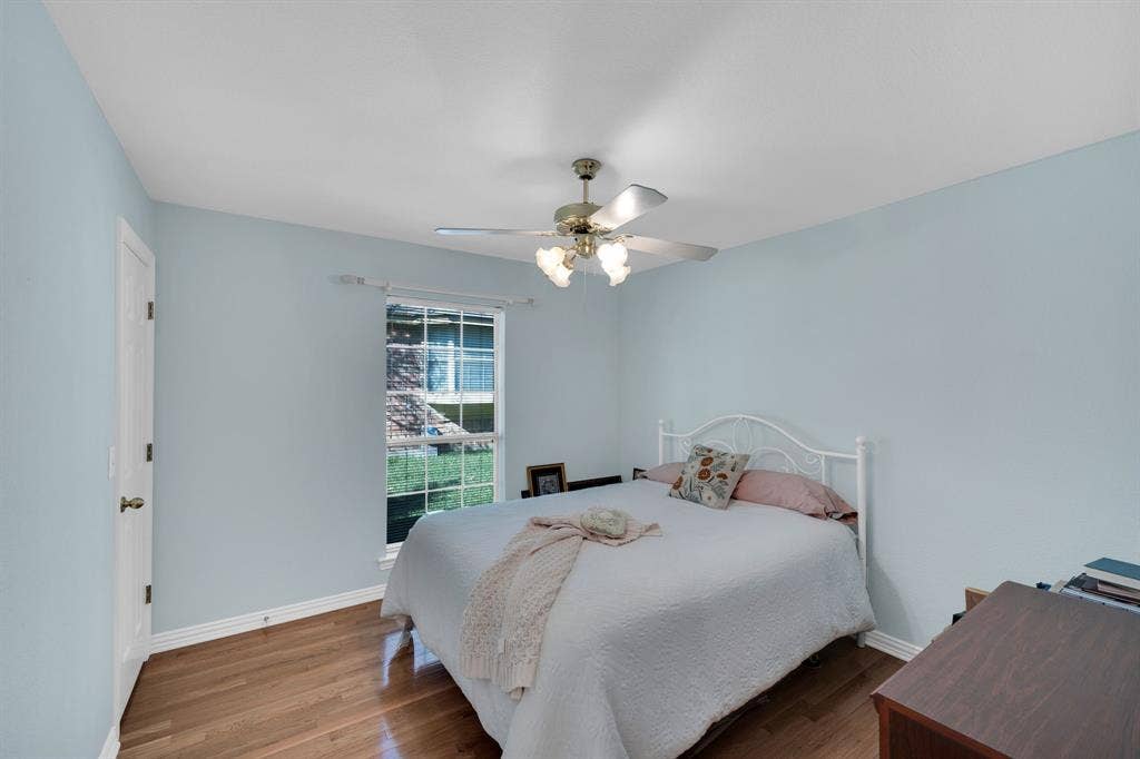 Bedroom with wood finished floors and ceiling fan