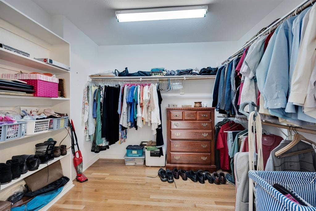 Spacious closet with light wood-style floors