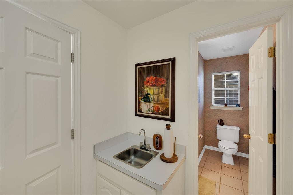 Bathroom featuring light tile patterned flooring and vanity