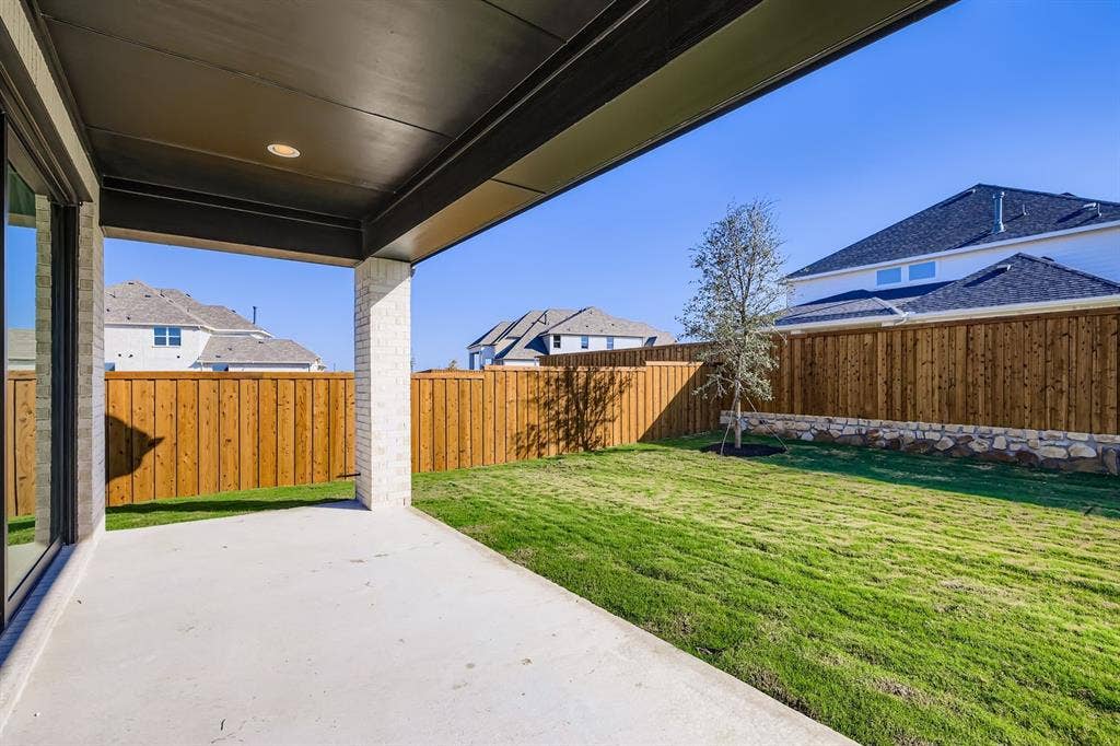 Fenced backyard with a patio area