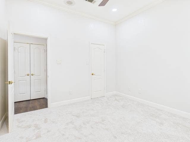 1178 E Oval Drive, Athens, TX 75751 Unfurnished bedroom featuring carpet flooring, ornamental molding, and ceiling fan