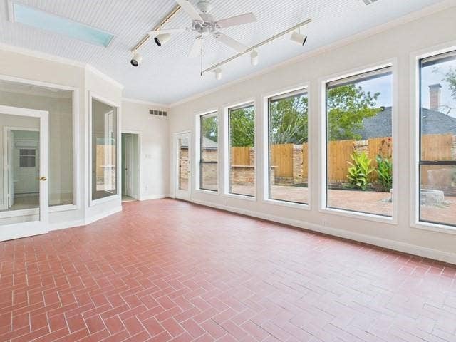 1178 E Oval Drive, Athens, TX 75751 Unfurnished sunroom with ornamental molding and rail lighting