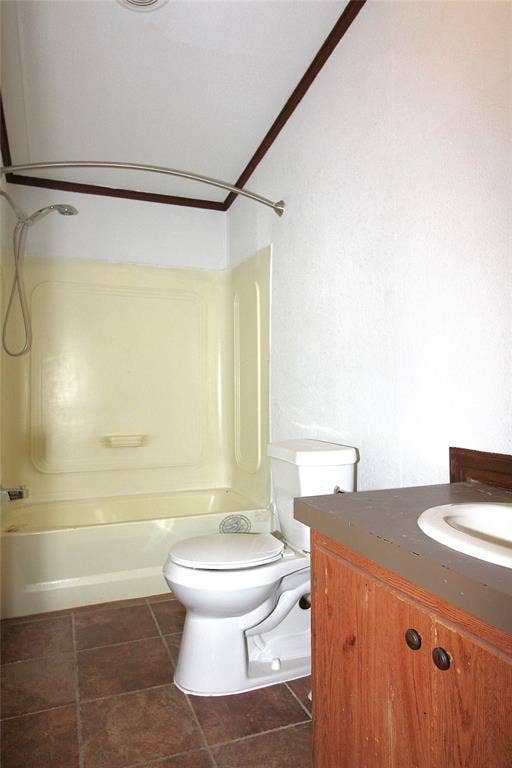 5199 Timarron Drive, Scurry, TX 75158 Bathroom #2featuring vanity, shower / bath combination, and dark tile patterned flooring