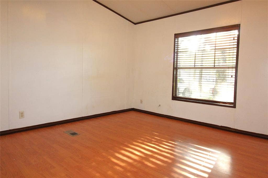 5199 Timarron Drive, Scurry, TX 75158 Bedroom #3Spare room featuring light wood-style flooring and crown molding