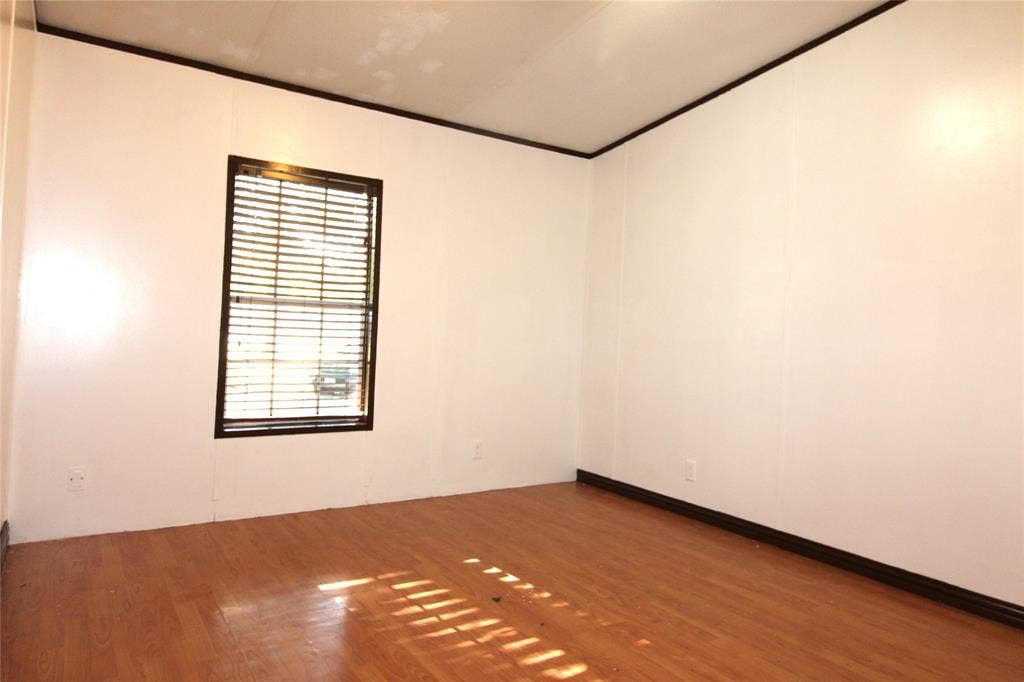 5199 Timarron Drive, Scurry, TX 75158 Bedroom #2 Spare room featuring wood finished floors