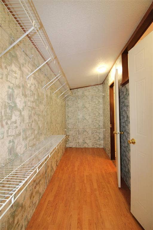 5199 Timarron Drive, Scurry, TX 75158 Spacious closet with wood finished floors