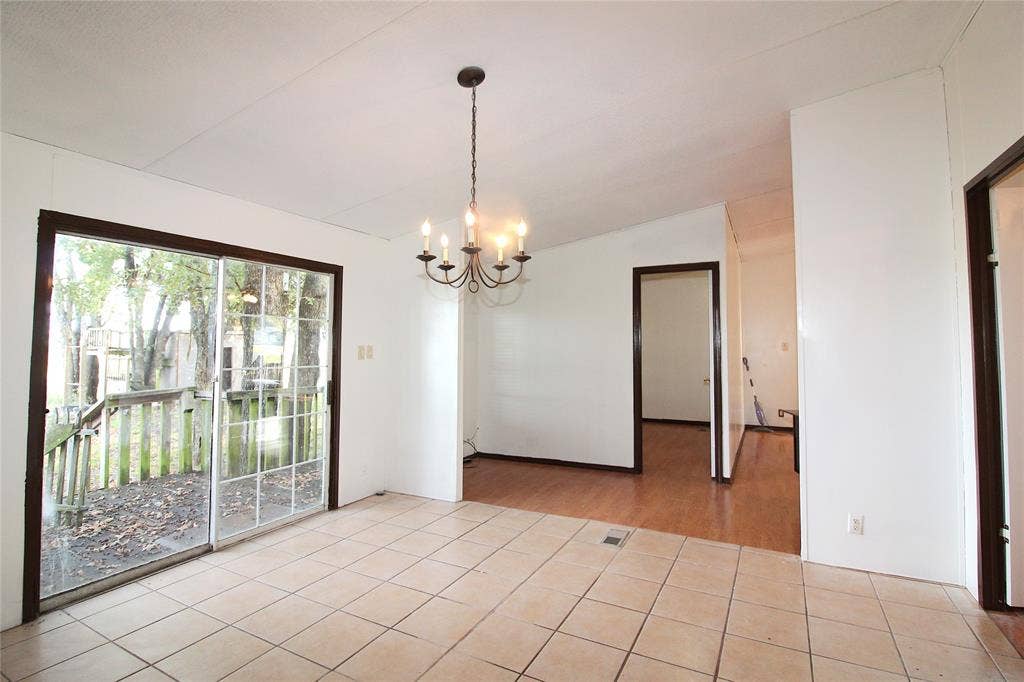 5199 Timarron Drive, Scurry, TX 75158 Empty room featuring a chandelier, light tile patterned floors, and lofted ceiling