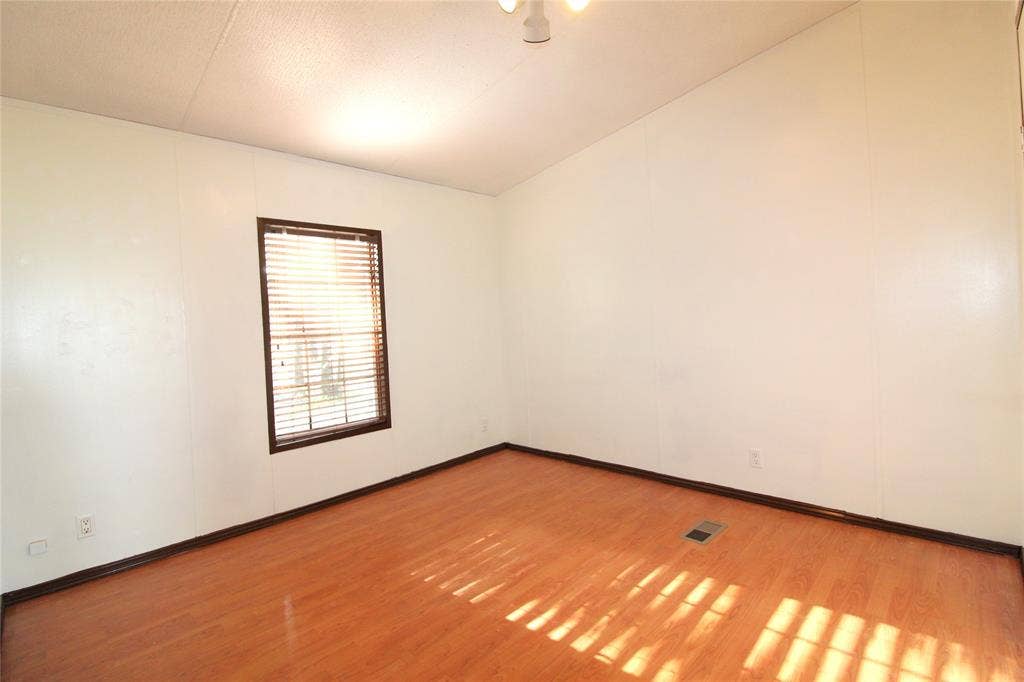 5199 Timarron Drive, Scurry, TX 75158 Bedroom #4Spare room featuring light wood-style floors and baseboards