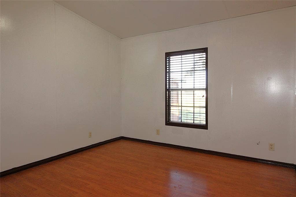 5199 Timarron Drive, Scurry, TX 75158 Bedroom #1Unfurnished room with wood finished floors and baseboards