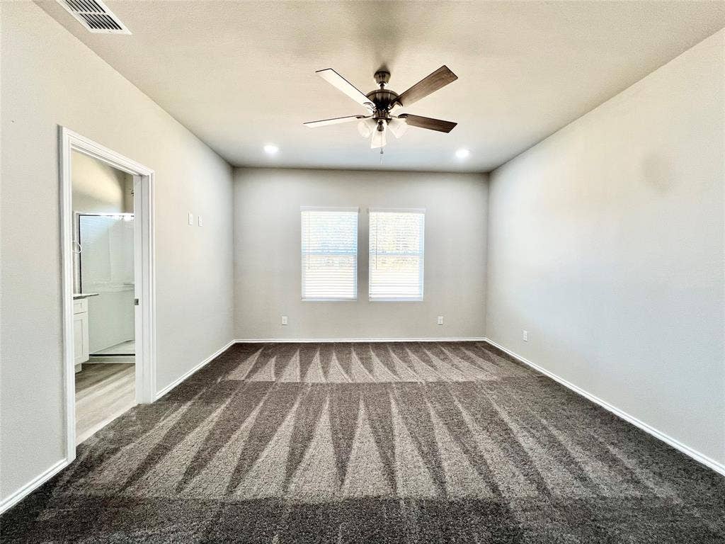 3501 E Renfro Street, #106, Burleson, TX 76028 Primary bedroom with dark carpet, ceiling fan, and recessed lighting