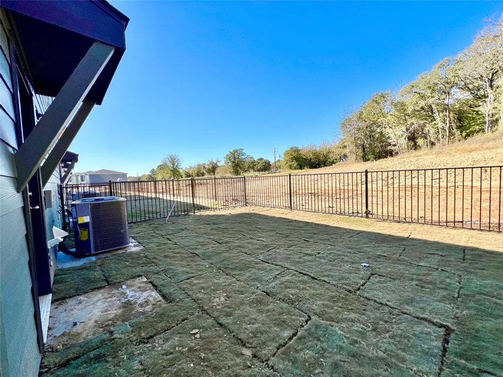 3501 E Renfro Street, #106, Burleson, TX 76028 Fenced backyard with a patio