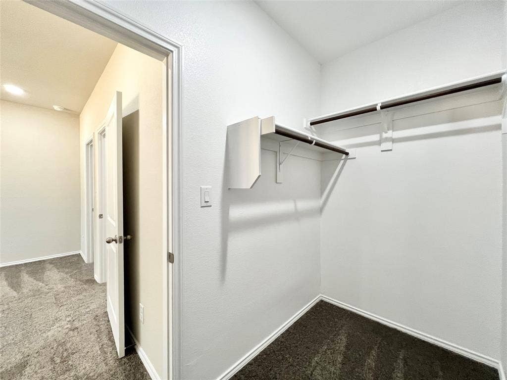 3501 E Renfro Street, #106, Burleson, TX 76028 2nd primary walk in closet featuring dark colored carpet