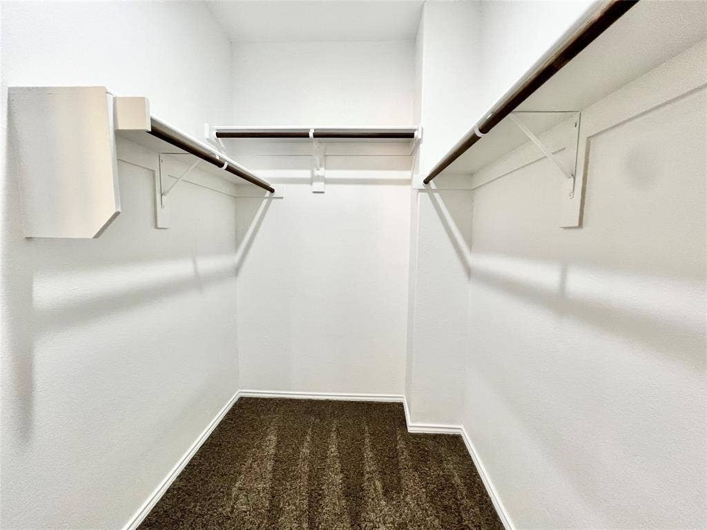 3501 E Renfro Street, #106, Burleson, TX 76028 2nd Primary walk in closet featuring dark colored carpet