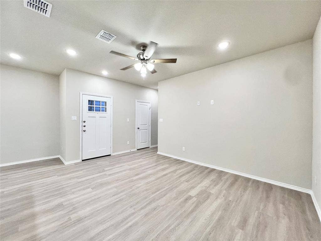 3501 E Renfro Street, #106, Burleson, TX 76028 Entry into living room with light wood-style floors, recessed lighting, and ceiling fan