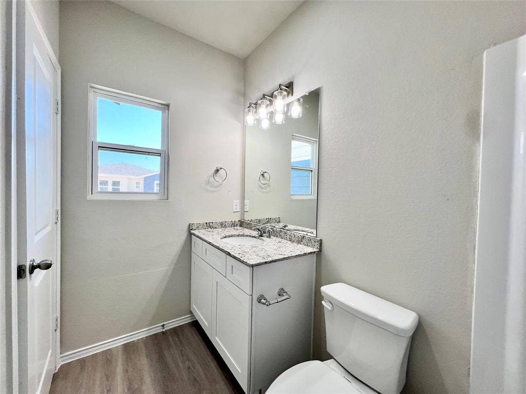 3501 E Renfro Street, #106, Burleson, TX 76028 Ensuite bathroom with dark wood-style flooring and vanity