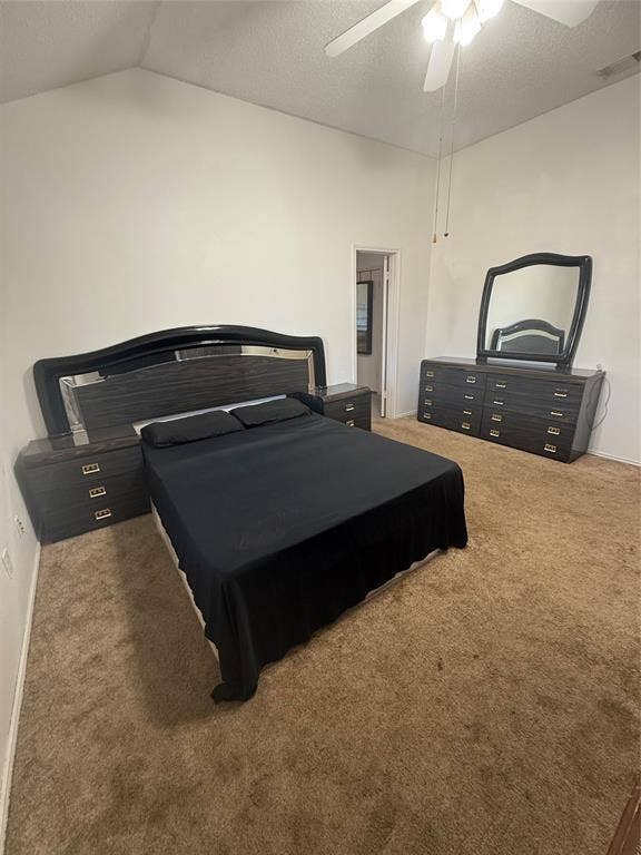 10216 Big Thicket Drive, Dallas, TX 75217 Bedroom featuring a textured ceiling, light colored carpet, a ceiling fan, and lofted ceiling