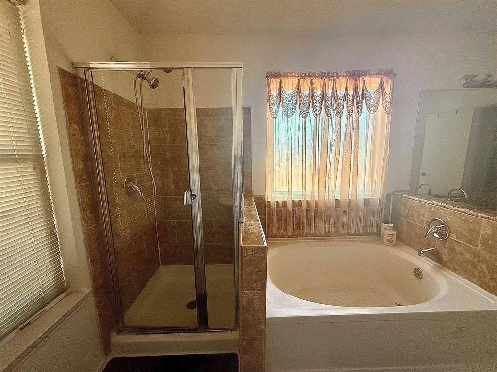 10216 Big Thicket Drive, Dallas, TX 75217 Full bathroom featuring a shower stall and a bath