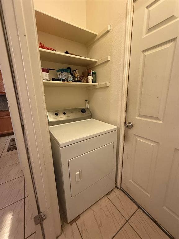 10216 Big Thicket Drive, Dallas, TX 75217 Washroom with washer / dryer and light marble finish floors