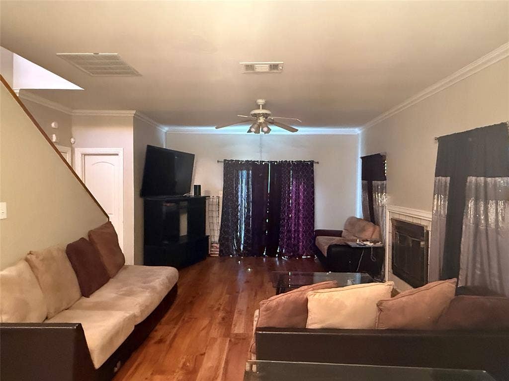 10216 Big Thicket Drive, Dallas, TX 75217 Living area with ceiling fan, crown molding, wood finished floors, and a tile fireplace