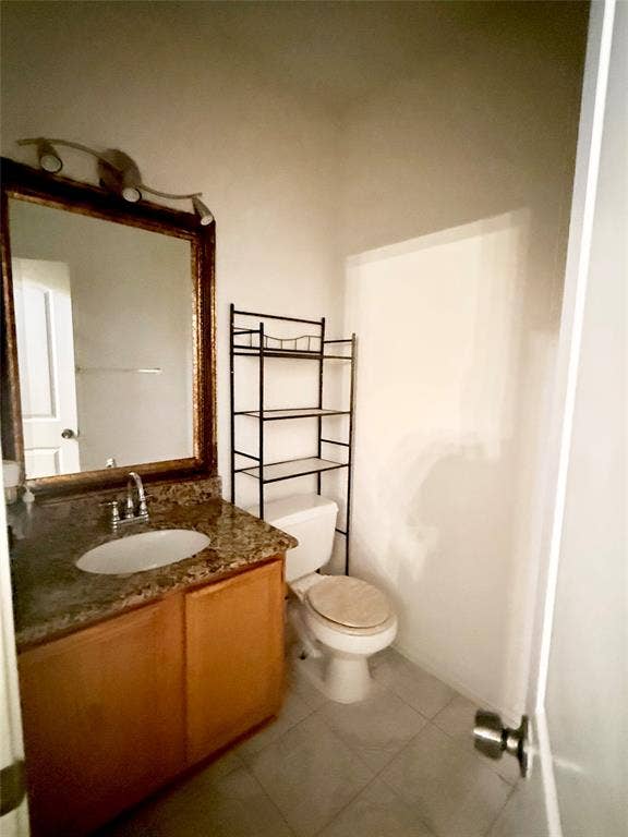 10216 Big Thicket Drive, Dallas, TX 75217 Half bath with vanity and light tile patterned floors