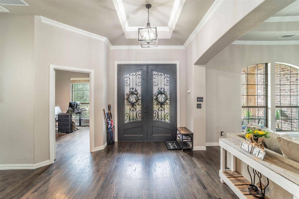 5229 Horseshoe Lane, Royse City, TX 75189 Foyer entrance featuring dark wood-style floors, ornamental molding, french doors, and a chandelier