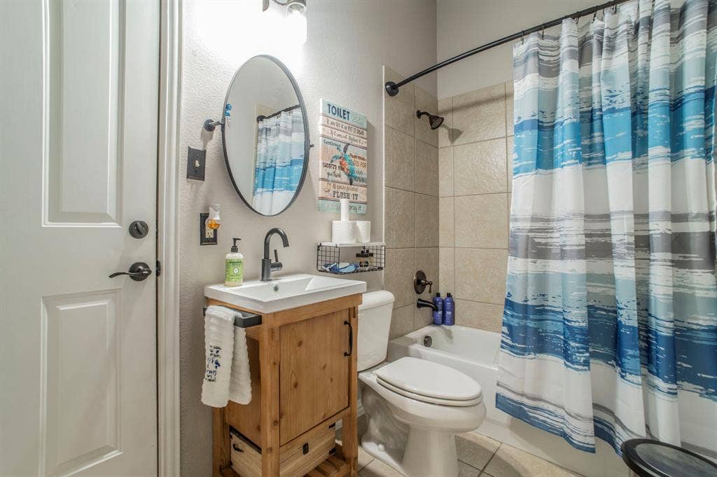 5229 Horseshoe Lane, Royse City, TX 75189 Full bathroom with tile patterned floors, shower / bath combination with curtain, vanity, and a textured wall