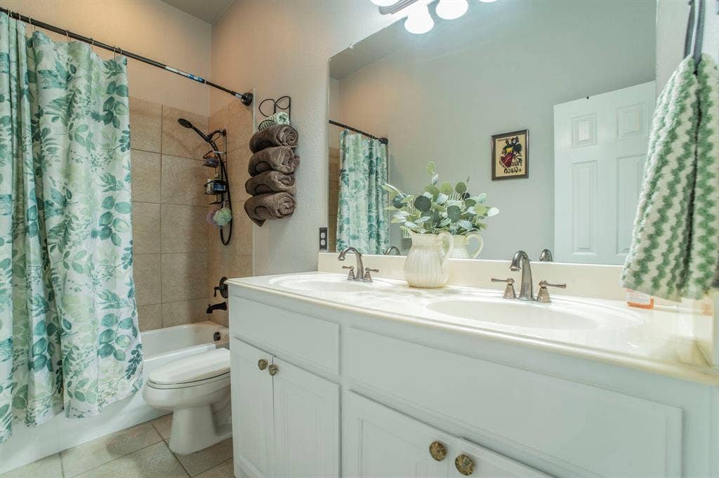 5229 Horseshoe Lane, Royse City, TX 75189 Full bathroom featuring shower / bath combo, double vanity, and light tile patterned floors