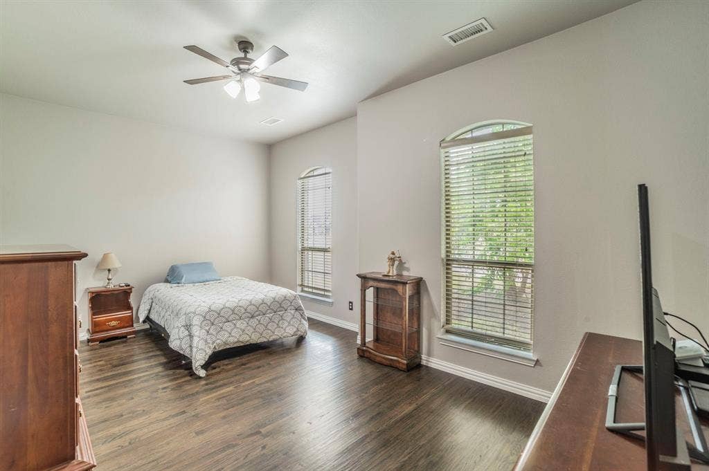 5229 Horseshoe Lane, Royse City, TX 75189 Bedroom featuring dark wood-style floors and a ceiling fan