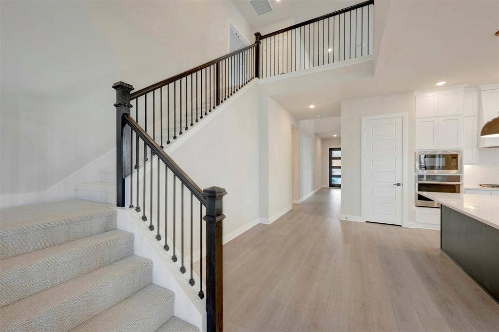 3752 Bermuda Grass Way, Grand Prairie, TX 76084 Stairs featuring wood finished floors, a high ceiling, and recessed lighting