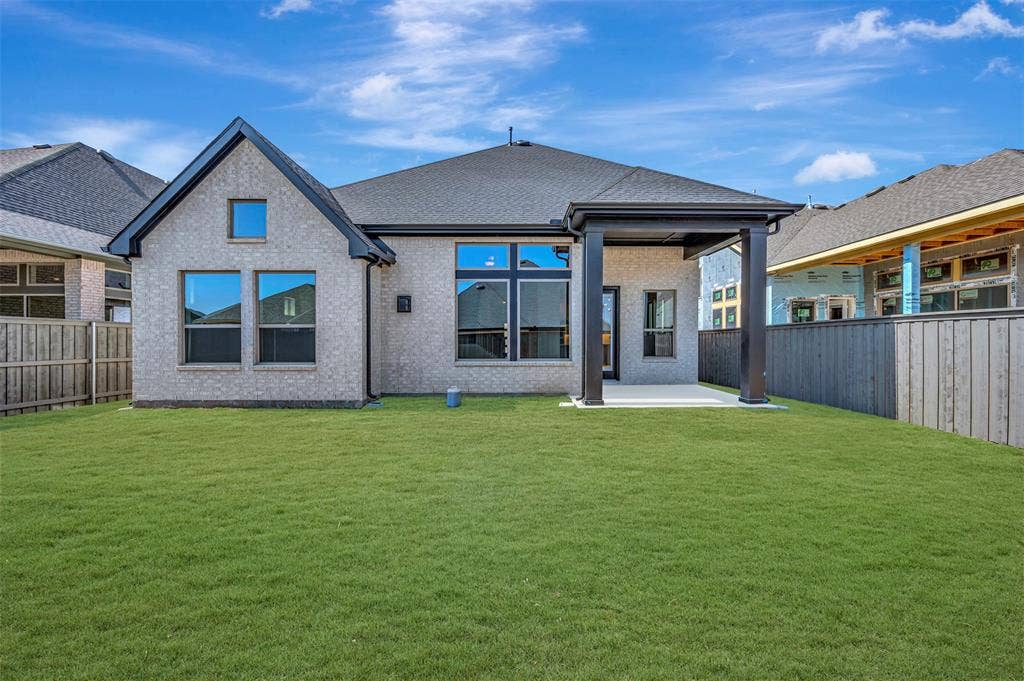 3752 Bermuda Grass Way, Grand Prairie, TX 76084 Rear view of house with a patio area, a fenced backyard, and brick siding