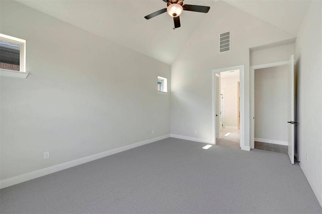 3752 Bermuda Grass Way, Grand Prairie, TX 76084 Unfurnished bedroom featuring carpet, lofted ceiling, and a ceiling fan