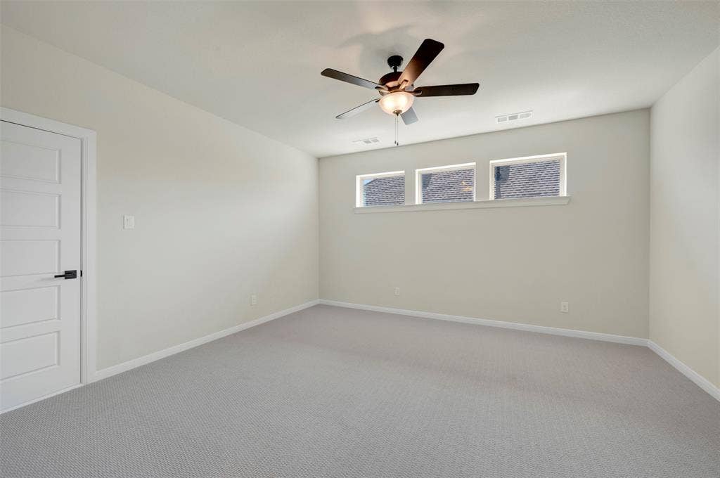 3752 Bermuda Grass Way, Grand Prairie, TX 76084 Unfurnished room featuring carpet and a ceiling fan