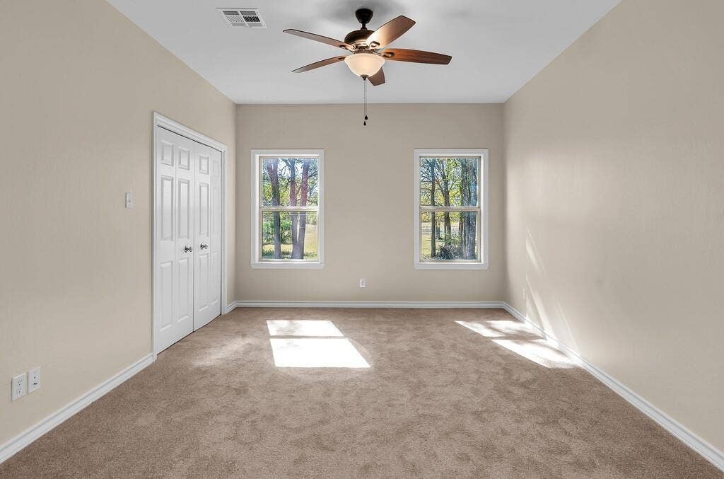 556 Wildwood Trail, Lorena, TX 76655 Unfurnished bedroom featuring carpet floors, a closet, and ceiling fan
