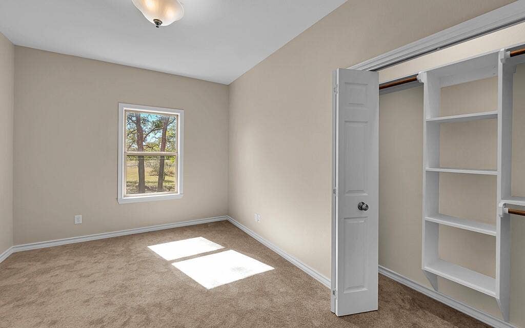 556 Wildwood Trail, Lorena, TX 76655 Unfurnished bedroom with carpet flooring