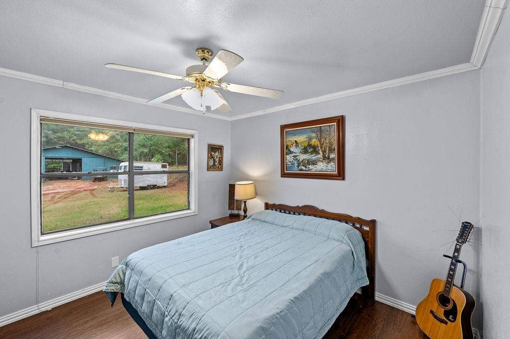 19418 CR 4125, Lindale, TX 75771 Bedroom with crown molding, wood finished floors, and a ceiling fan