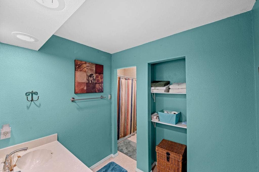 19418 CR 4125, Lindale, TX 75771 Bathroom with curtained shower, vanity, and light tile patterned flooring