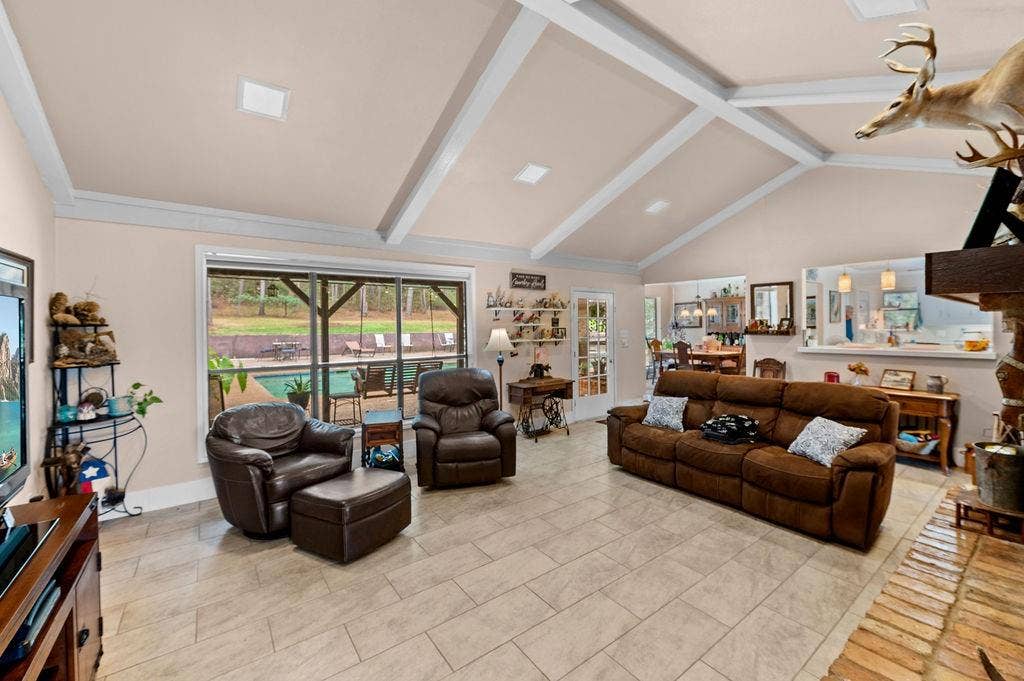 19418 CR 4125, Lindale, TX 75771 Living area featuring beamed ceiling, high vaulted ceiling, and light tile patterned floors