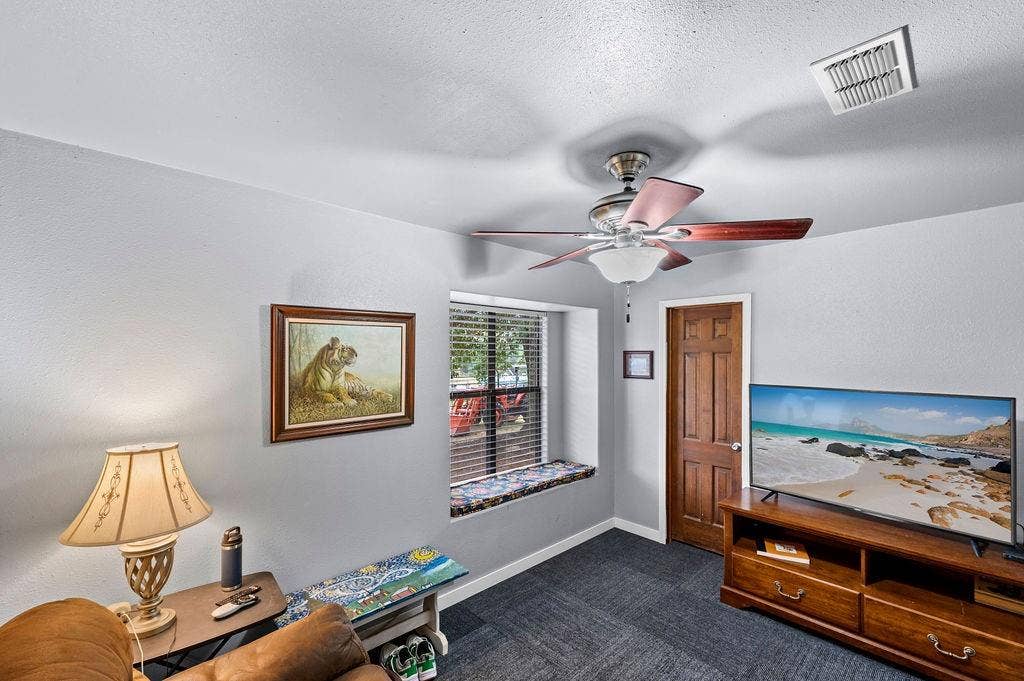 19418 CR 4125, Lindale, TX 75771 Home office featuring dark carpet, a textured ceiling, and a ceiling fan