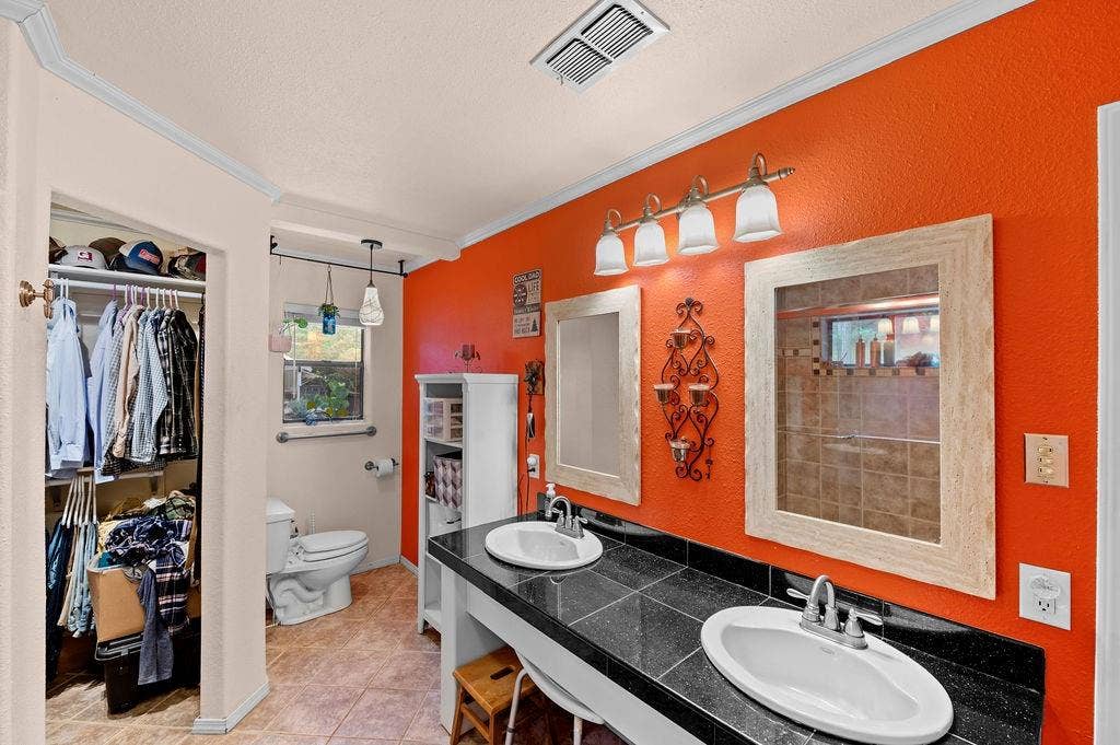 19418 CR 4125, Lindale, TX 75771 Bathroom featuring a spacious closet, ornamental molding, light tile patterned floors, double vanity, and a textured wall
