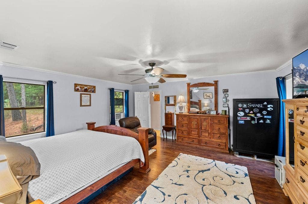 19418 CR 4125, Lindale, TX 75771 Bedroom featuring dark wood-style flooring, ornamental molding, and ceiling fan