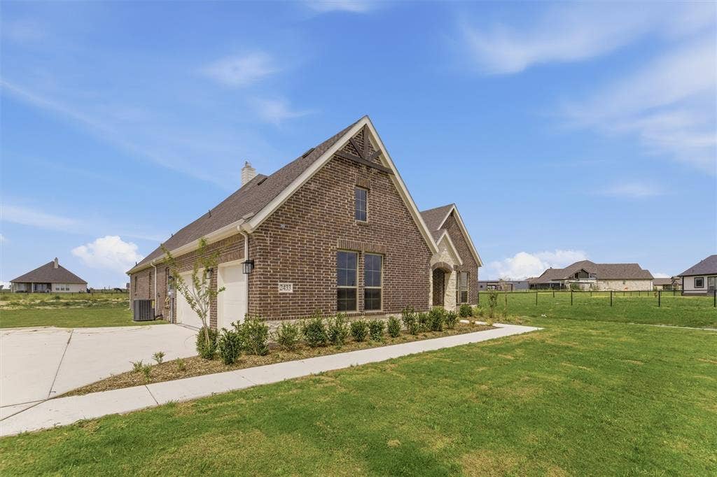 Brick exterior with stone accents, featuring a prominent front gable and a two-car garage