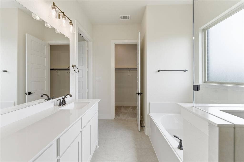 Dual vanity with white cabinetry and countertops